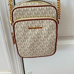 Michael Kors white and brown crossbody with signature monogram MK.